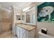 Bright bathroom boasts granite counters, modern vanity, and a glass-enclosed shower with neutral tile at 17118 Vardon Ter # 101, Bradenton, FL 34211