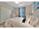 Comfortable bedroom with a large window, plush bedding, and ample closet space at 17118 Vardon Ter # 101, Bradenton, FL 34211