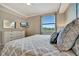 Comfortable bedroom with a plush bed, dresser, mirror, and large window providing natural light at 17118 Vardon Ter # 101, Bradenton, FL 34211