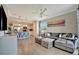 Open-concept living room with a comfortable sectional, TV, and view into the modern kitchen at 17118 Vardon Ter # 101, Bradenton, FL 34211