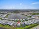 An aerial view highlights the home's location within a community, near a central lake at 17502 Savory Mist Cir, Bradenton, FL 34211