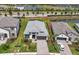 An aerial view showcases the home's front facade, well-manicured landscaping, and paver driveway at 17502 Savory Mist Cir, Bradenton, FL 34211