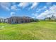 A large, well-kept backyard features a screened-in pool, perfect for relaxation and outdoor activities at 17502 Savory Mist Cir, Bradenton, FL 34211