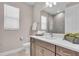 Bright bathroom featuring a quartz countertop, wooden cabinets, and a window at 17502 Savory Mist Cir, Bradenton, FL 34211