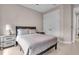 Comfortable bedroom featuring a ceiling fan, a soft bed with a gray tufted headboard, and a convenient nightstand at 17502 Savory Mist Cir, Bradenton, FL 34211