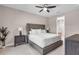Comfortable bedroom with a tufted headboard, ceiling fan, and stylish nightstands with lamps providing a relaxing ambiance at 17502 Savory Mist Cir, Bradenton, FL 34211