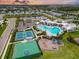 Aerial view showcasing a community pool, basketball court, playground and tennis courts at 17502 Savory Mist Cir, Bradenton, FL 34211