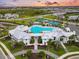 Aerial view of a resort-style pool and amenities with lush landscaping and community spaces at 17502 Savory Mist Cir, Bradenton, FL 34211