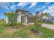 Lawn view of house with a two car garage, neatly landscaped yard and a paver driveway at 17502 Savory Mist Cir, Bradenton, FL 34211