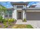 Inviting single-Gathering home featuring a two-car garage and charming landscaping at 17502 Savory Mist Cir, Bradenton, FL 34211