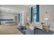 Open concept lounge, featuring a bar and dining area, with stylish seating and lots of natural light at 17502 Savory Mist Cir, Bradenton, FL 34211