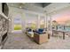 Inviting outdoor lounge with comfortable seating, fireplace, and views of the pool at 17502 Savory Mist Cir, Bradenton, FL 34211