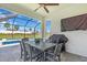 Covered patio with outdoor dining table and chairs, ceiling fan, television, and swimming pool view at 17502 Savory Mist Cir, Bradenton, FL 34211