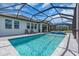 This pool has a spa with a waterfall feature, gray pavers, and a view of the side of the home at 17502 Savory Mist Cir, Bradenton, FL 34211