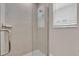 Tiled shower with glass door and window provides natural light at 17502 Savory Mist Cir, Bradenton, FL 34211