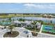 Aerial view of community amenities including pool, tennis courts and lakefront access, perfect for leisure at 18044 Cherished Loop, Bradenton, FL 34211