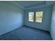 Bright bedroom with carpet flooring and windows overlooking the front yard at 18044 Cherished Loop, Bradenton, FL 34211