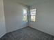 Cozy bedroom with carpet flooring and natural light streaming through the double windows at 18044 Cherished Loop, Bradenton, FL 34211