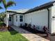 Charming home exterior with manicured landscaping and brick walkway that welcomes visitors with curb appeal at 18044 Cherished Loop, Bradenton, FL 34211