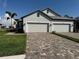 Well-maintained home with a spacious three-car garage and a manicured lawn at 18044 Cherished Loop, Bradenton, FL 34211