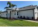 Charming home features a gray tile roof, brick walkway, two-car garage, and a neatly landscaped yard at 18044 Cherished Loop, Bradenton, FL 34211