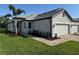 Beautifully landscaped home featuring a brick walkway, gray tile roof, and a two-car garage at 18044 Cherished Loop, Bradenton, FL 34211