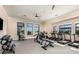 Modern gym featuring a variety of fitness equipment and ample natural light from large windows at 18044 Cherished Loop, Bradenton, FL 34211