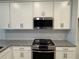 Modern kitchen features granite countertops, stainless steel appliances, and white cabinets at 18044 Cherished Loop, Bradenton, FL 34211