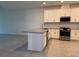 Modern kitchen features stainless steel appliances, granite countertops, white cabinetry, and tile floors at 18044 Cherished Loop, Bradenton, FL 34211