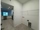 Inside laundry room with connections, with a view of the modern kitchen at 18044 Cherished Loop, Bradenton, FL 34211