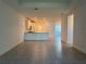 An expansive living area featuring tile floors, an open layout, and seamlessly connecting to the kitchen at 18044 Cherished Loop, Bradenton, FL 34211