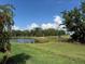 Scenic view of the pond and lush landscaping showcasing the beauty of the community and peaceful surroundings at 18044 Cherished Loop, Bradenton, FL 34211