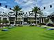 Community green space for recreation featuring palm trees, lawn games, and ample parking at 18044 Cherished Loop, Bradenton, FL 34211