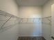 Spacious walk-in closet with wire shelving for organizing clothes and accessories at 18044 Cherished Loop, Bradenton, FL 34211