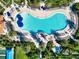 Aerial view of a lagoon style community pool surrounded by lush green landscaping at 19921 Petrino St, Venice, FL 34293