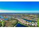Expansive aerial showcases a community with waterways winding through residences with red-tiled roofs at 19921 Petrino St, Venice, FL 34293