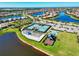 Aerial view of the community's tennis courts, playground, and outdoor seating area next to beautiful neighborhood at 19921 Petrino St, Venice, FL 34293