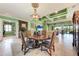Elegant dining room with chandelier, and views of the pool and outdoor living area at 19921 Petrino St, Venice, FL 34293