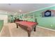 Spacious game room featuring a pool table, dart board, and a comfortable office area at 19921 Petrino St, Venice, FL 34293