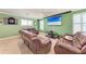 Living room with a big screen, plush seating, dart board, and lots of space for entertaining at 19921 Petrino St, Venice, FL 34293