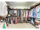 Organized walk-in closet with shelving, hanging rods, and storage for clothes, shoes, and accessories at 19921 Petrino St, Venice, FL 34293