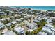 Charming aerial view of a coastal home with a pool, palm trees, and ocean proximity at 214 Palm Ave, Anna Maria, FL 34216