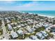 Picturesque aerial view of homes and vibrant community near the white sandy beach and ocean at 214 Palm Ave, Anna Maria, FL 34216
