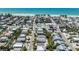 Lovely aerial view of neighborhood with homes, businesses, and palm trees near the beach at 214 Palm Ave, Anna Maria, FL 34216