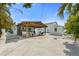 Expansive backyard showcasing a covered patio, dining area, outdoor seating, and lush landscaping, perfect for entertaining and relaxation at 214 Palm Ave, Anna Maria, FL 34216