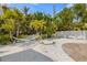 Backyard oasis featuring a hammock and lush landscaping, offering a serene escape and relaxation in a private outdoor setting at 214 Palm Ave, Anna Maria, FL 34216