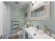 Charming bathroom with a vanity, decorative mirror, toilet, and shower with curtain at 214 Palm Ave, Anna Maria, FL 34216