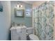 This bathroom features a classic vanity, decorative mirror, and shower/tub combo, creating a cozy and functional space at 214 Palm Ave, Anna Maria, FL 34216
