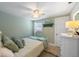 Relaxing bedroom with a ceiling fan, and soft bedding, complemented by a 'Beach' decor at 214 Palm Ave, Anna Maria, FL 34216