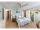 Inviting bedroom with coastal decor, ceiling fan, tiled floors, and two entryways at 214 Palm Ave, Anna Maria, FL 34216